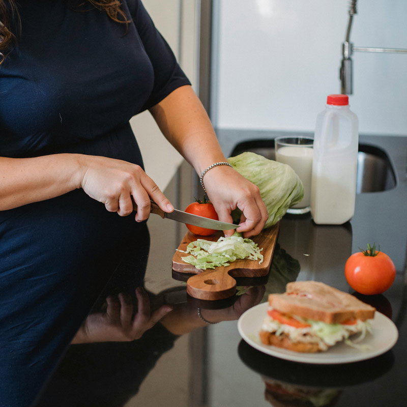 person cutting lettuce